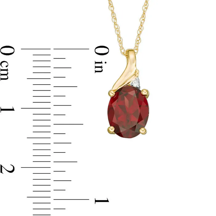 Goldia Necklaces Oval Garnet and Natural Diamond Accent Swirl Top Pendant in 10K Yellow Gold